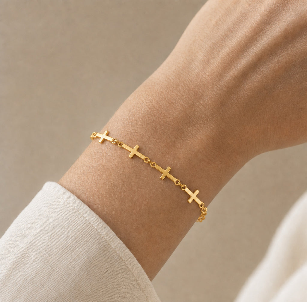 Gold linked cross bracelet worn