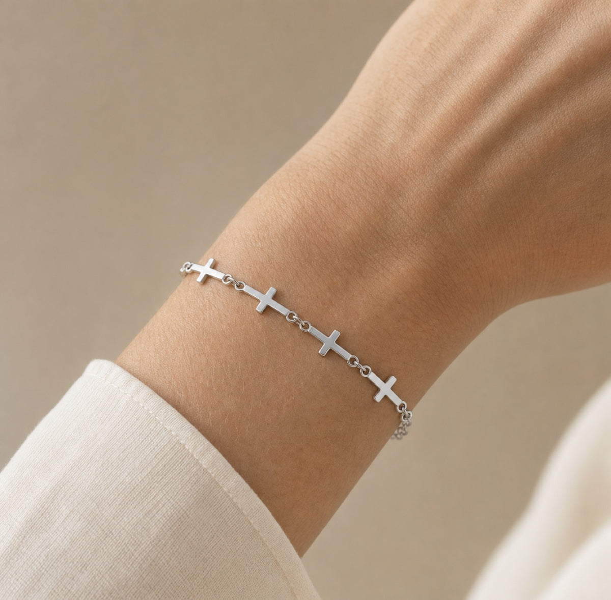 Silver linked cross bracelet worn