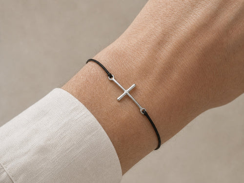 Silver cross cord bracelet worn